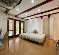 4 izbová celoročná chata v Kučišdorfskej doline na predaj - Interiér chaty s posteľou, stoličkou a podlahou s dreveným dekorom.