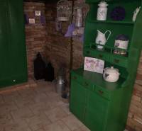 MH283 – Na predaj krásny rodinný dom vo vidieckom štýle - Rodinný dom s tehlovou stenou, zeleným nábytkom a dekoráciami s levanduľovým motívom.