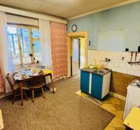 Na predaj 4-izbový rodinný dom v Brodzanoch – pozemok 1236 m² - Kuchyňa v rodinnom dome s jedálenským stolom, plynový sporák a umývadlo.