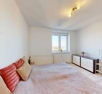 ZREKONŠTRUOVANÝ 3-IZBOVÝ BYT (74 m2) S BALKÓNOM, PIVNICOU, 2 x WC - Spálňa v 3-izbovom byte s posteľou, komodou a poličkou, podlaha s dreveným dekorom.