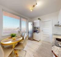 ZREKONŠTRUOVANÝ 3-IZBOVÝ BYT (74 m2) S BALKÓNOM, PIVNICOU, 2 x WC - Kuchyňa v 3-izbovom byte so svetlou podlahou a jedálenským stolom.