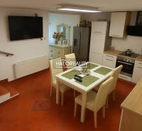 Predaj, rodinný dom Košice Juh - Kuchyňa v rodinnom dome s kachličkovou podlahou, jedálenským stolom a kuchynskou linkou.