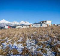 Stavebný pozemok v lokalite Medzi Vodami - Pozemky na bývanie v Mlynici s panoramatickým výhľadom a modernými stavbami v pozadí.