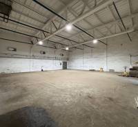 Prenájom nových kancelárskych priestorov a skladov na Teplickej ulici  - Priestor s betónovou podlahou a svetlami, využiteľný ako kancelárie v Poprade.