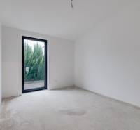 Novostavba samostatne stojaceho RD v štandarde, nízka spotreba - Prázdna miestnosť v rodinnom dome s betónovou podlahou a záhradným výhľadom.