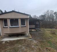 Pohoda pri vode, chata s výhľadom na Domašu - Chata na Hlavnej ulici v Novej Kelči obklopená stromami a mierne svahovitým terénom.