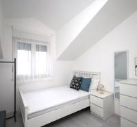 Vodice – novo zrekonštruovaný dvojspálňový apartmán s výhľadom na more - Svetlá izba s posteľou, zrkadlom a dekoráciami v Rekreačnom apartmáne.