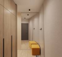 Prémiové byty s vysokým investičným potenciálom - Interiér budovy s podlahou s dreveným dekorom, šatník, zrkadlo a žlté sedenie.