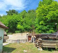 Rodinný dom po čiastočnej rekonštrukcii - Rodinný dom v Hajnáčke s drevom a zeleňou na dvore, obklopený bujnou prírodou.