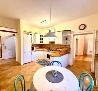 Horský Park:Na prenájom veľkometrážny, 4i, charizmatický byt - Kuchyňa v 4-izbovom byte s podlahou s dreveným dekorom a jedálenským stolom.