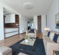 REZERVOVANÝ! Nová cena! Moderný 2-izbový byt – Galanta, sídlisko West - Obývacia izba v 2-izbovom byte s podlahou s dreveným dekorom a pohodlnými sedačkami.