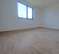 REZERVOVANÉ! Posledná novostavba 4-izbového dvojdomu v štandarde - Priestranná miestnosť s podlahou s dreveným dekorom a veľkým oknom v rodinnom dome.