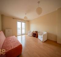 Rezervované: Na predaj pekný 2-izbový byt v centre mesta Poprad - Obývačka v 2-izbovom byte s podlahou s dreveným dekorom, pohovkou a kreslami.