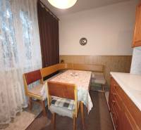 NA PREDAJ • 3i BYT S LOGGIOU • KALINČIAKOVA ULICA, SENICA - Jedálenský kút so stolom a stoličkami v 3-izbovom byte s podlahou s dreveným dekorom.