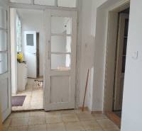 Predám Rodinný dom v Strekove - Interiér rodinného domu s bielymi dverami a podlahou z dlaždíc.