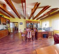 Veľkometrážny dom s wellness, bazénom a investičným potenciálom - Rodinný dom s kuchyňou, podlahou s dreveným dekorom a kúskom pracoviska v rohu miestnosti.