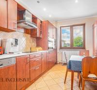 NA PREDAJ 5-IZBOVÝ POSCH. RODINNÝ DOM, DUNAJSKÁ STREDA - Kuchyňa v rodinnom dome s dreveným nábytkom, spotrebičmi a jedálenským stolom.