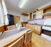 REZERVOVANÉ/ 3- izbový byt blízko centra mesta, Vrbové - Kuchyňa v 3-izbovom byte s jedálenským stolom a drevenými skrinkami.