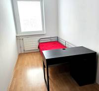 Útulný byt s loggiou a klimatizáciou, Rovniankova.Províziu neplatíte - Úzka izba s posteľou, stolom a podlahou s dreveným dekorom v 3-izbovom byte.