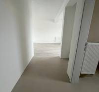 REZERVOVANÉ! Na predaj 2 izb. byt blízko centra, Chorvátsky Grob - Chodba s bielymi stenami a podlahou s dreveným dekorom v 2-izbovom byte.