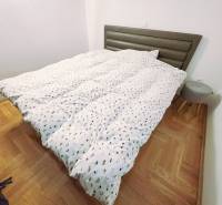 Chorvátsko, Makarska - zariadený apartmán s výhľadom na more - Rekreačný apartmán s posteľou, dreveným dekorom podlahy a malým nočným stolíkom.