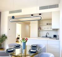 Prenájom 3-izbový byt s loggiou, SKY PARK, Bratislava - Jedálenský kút s presvetleným skleneným stolom, štyrmi stoličkami a kuchyňou v 3-izbovom byte.