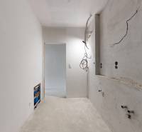 3i. BYT S VLASTNÝM TEP. ČERPADLOM + KLIMATIZÁCIA A EXTERIÉROVÉ ŽALÚZIE - Nedokončená kuchyňa v 3-izbovom byte s bielymi stenami a voľnými káblami.