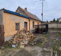 Na predaj 2 izbový rodinný dom s pozemkom - Dvory nad Žitavou - Rodinný dom v Dvoroch nad Žitavou s hromadou tehál a starou fasádou.