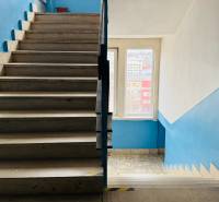 Kancelária s výhľadom na centrum Michaloviec. 16 m2 - Schodisko vo vnútorných priestoroch Kancelárie s modrými stenami a svetlými dlaždicami.