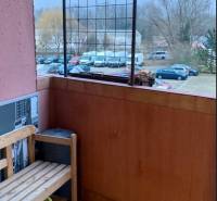 Prenájom 3 izbový byt, ulica Jána Poničana, BA IV. Devínska Nová Ves - Balkón s drevenou lavičkou, výhľad na zaparkované autá, ulica Jána Poničana, Bratislava - Devínska Nová Ves.