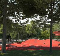 Vyššie už je nebo. 3izbový byt po kompletnej rekonštrukcii  - Park s červeným ihriskom na ulici Golianova v Trnave obklopený stromami a lavičkami.