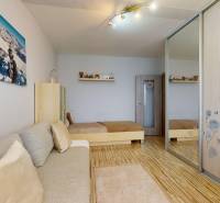 Vyššie už je nebo. 3izbový byt po kompletnej rekonštrukcii  - Izba so sedačkou, jedným lôžkom, skriňou so zrkadlom a podlahou s dreveným dekorom.