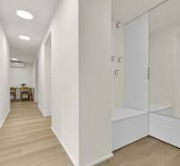 I Na predaj zrekonštruovaný 4i byt v Ružinove, Miletičova - Chodba v 4-izbovom byte s podlahou s dreveným dekorom a zrkadlovou stenou.