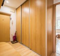 Pozrite si PRÍJEMNÝ 2i byt so ZARIADENÍM, LODŽIOU a KLIMATIZÁCIOU - Vstupná chodba s podlahou s dreveným dekorom a vstavanou skriňou v 2-izbovom byte.