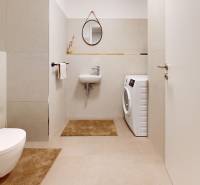 METROPOLIS I Nový Luxusný 2i byt s predzáhradkou I - Kúpeľňa 2-izbového bytu s práčkou, umývadlom a okrúhlym zrkadlom na stene.