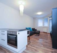 Predaj útulný 2 izbový byt, novostavba, super lokalita Jégeho ulica. - Kuchynský kútik a obývacia izba v 2-izbovom byte so sporákom a pohovkou.