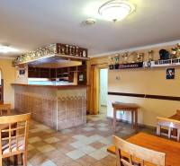 Predaj Domu (obchodného priestoru) v obci Lovča - Interiér rodinného domu so stolmi, barom a vystavenými trofejami.