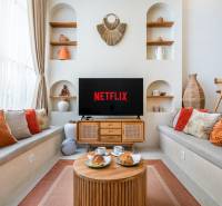 LUXUSNÁ 3-SPÁLŇOVÁ VILA S BAZÉNOM – CANGGU, BALI - Pohodlná obývačka vo vile s televízorom, vankúšmi a dekoráciami, podáva sa káva.