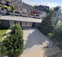 Na prenájom 3i byt v rodinom dome so záhradou - Vojenská ul. Rovinka - Záhrada s kameňmi, stromami a plotom na ulici Vojenská, oproti rodinnému domu.