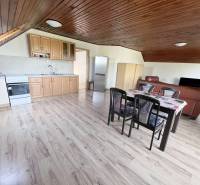 Na prenájom 3i byt v rodinom dome so záhradou - Vojenská ul. Rovinka - Kuchyňa v 3-izbovom byte na ulici Vojenská, drevený strop, jedálenský stôl, kožená sedačka.