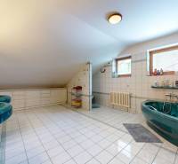 Na predaj Rodinný dom -rezort - Banská Bystrica 4500m2 - Priestranná kúpeľňa v rodinnom dome s vaňou, umývadlami a oknami s keramickým obkladom.