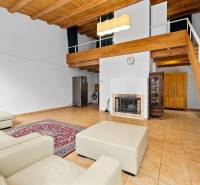 – EXKLUZÍVNE – NA PRENAJOM – DOM – MEDZIERKA – STARÉ MESTO - Obývačka s krbom, koženým gaučom, kamennou dlažbou a dreveným stropom v rodinnom dome.