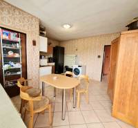 5.izb RD Čereňany pozemok 1028m - Kuchyňa v rodinnom dome s jedálenským stolom, tapetami a vstavanými skrinkami.