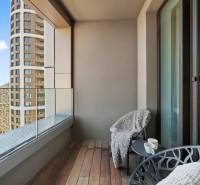NUERA︱SKY PARK nadštandardný zariadený 2-izbový byt na 15. poschodí - Balkón s výhľadom na moderné budovy, pohodlné kreslá, podlaha s dreveným dekorom.