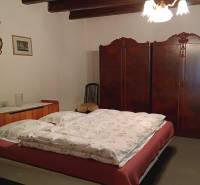 Na Predaj Rodinný dom pozemok 1587 m² v Horných Salibách  - Spálňa v rodinnom dome s posteľou, vstavanou skriňou a vidieckym dekorom.