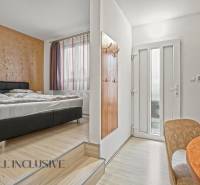 NA PREDAJ APARTMÁNOVÝ DOM VO VEĽKOM MEDERI - Ubytovacie priestory s posteľou, podlahou s dreveným dekorom, stolom a svetlým dizajnom. Hotely a penzióny.