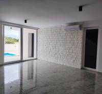 VRSI - dvojdom s bazénom a záhradou - Obývacia izba s mramorovou podlahou a posuvnými dverami v rodinnom dome.