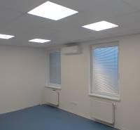 Prenájom klimatizovanej kancelárie, 24 m² – Trnava, Bulharská ulica - Kancelárie s bielym stropom, modrou podlahou a oknami so žalúziami.