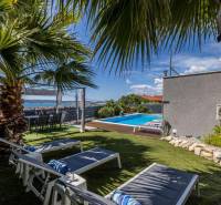 Kaštela(HR)-moderná vila s krásnym výhľadom - Útulná záhrada s bazénom vo vile v Kaštele, obklopená palmami a ležadlami.