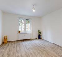 PREDAJ - 4-izb. byt na Sklenárovej ul., 67 m2, komplet. rekonštrukcia - Izba v 4-izbovom byte s podlahou s dreveným dekorom a jednoduchým zariadením.
